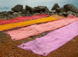 lengths of bright cloth with stones at each corner